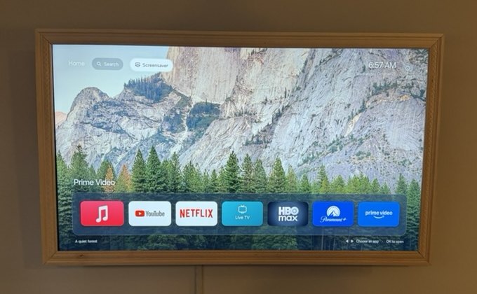 My new TV Home screen: a mountain and forest wallpaper with a single dock of my favorite apps